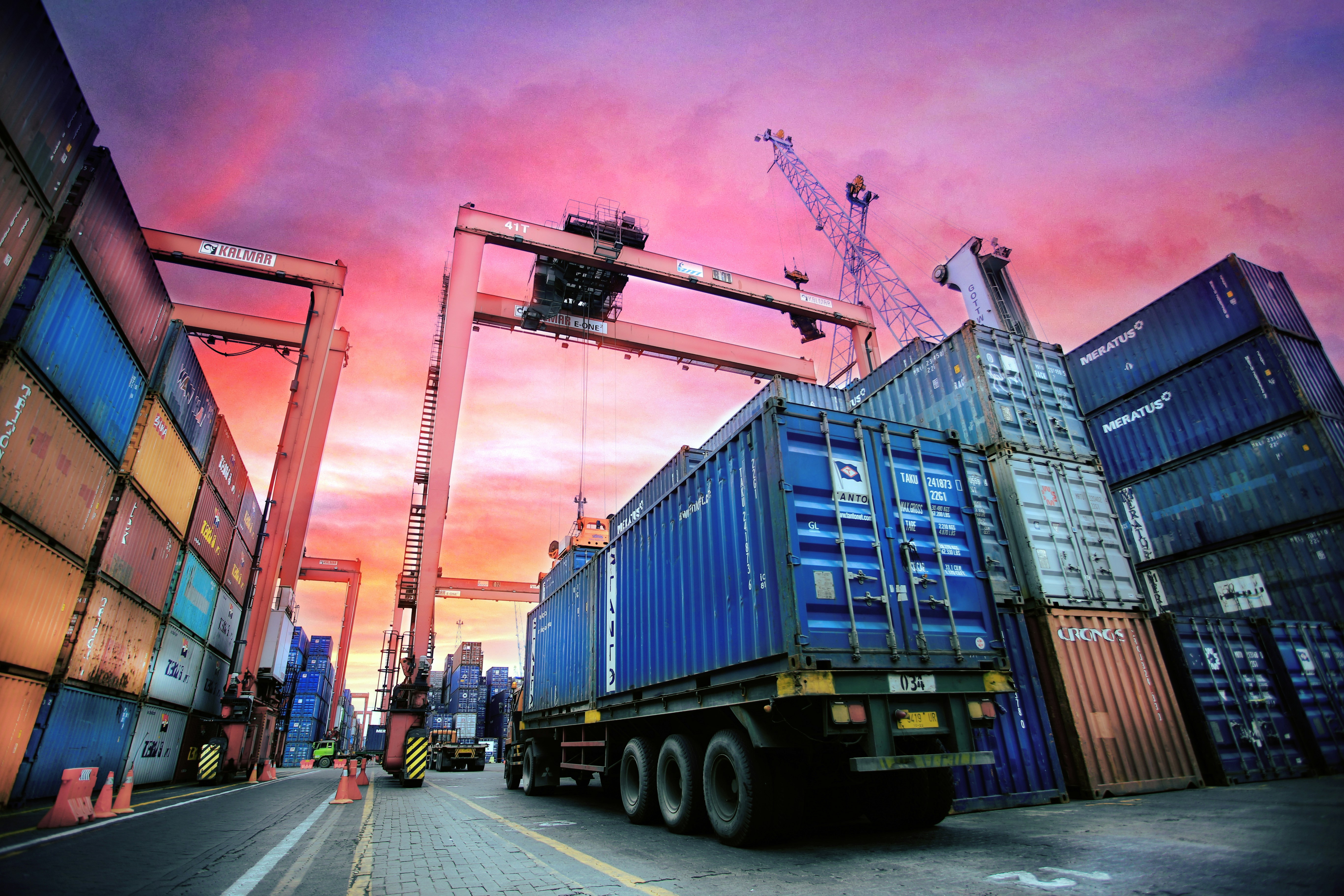 Shipping containers at port at sunset