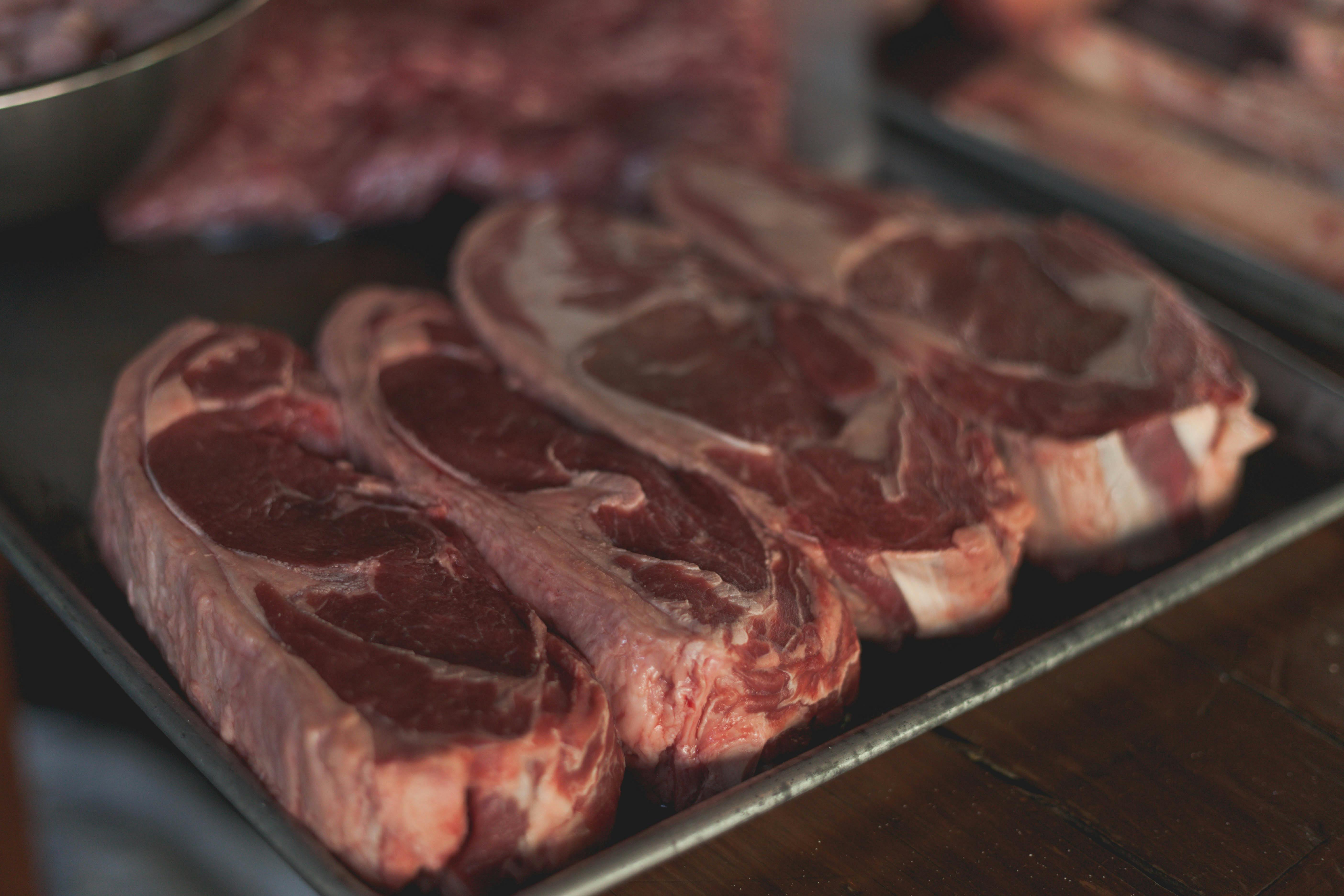 Raw beef steaks on tray