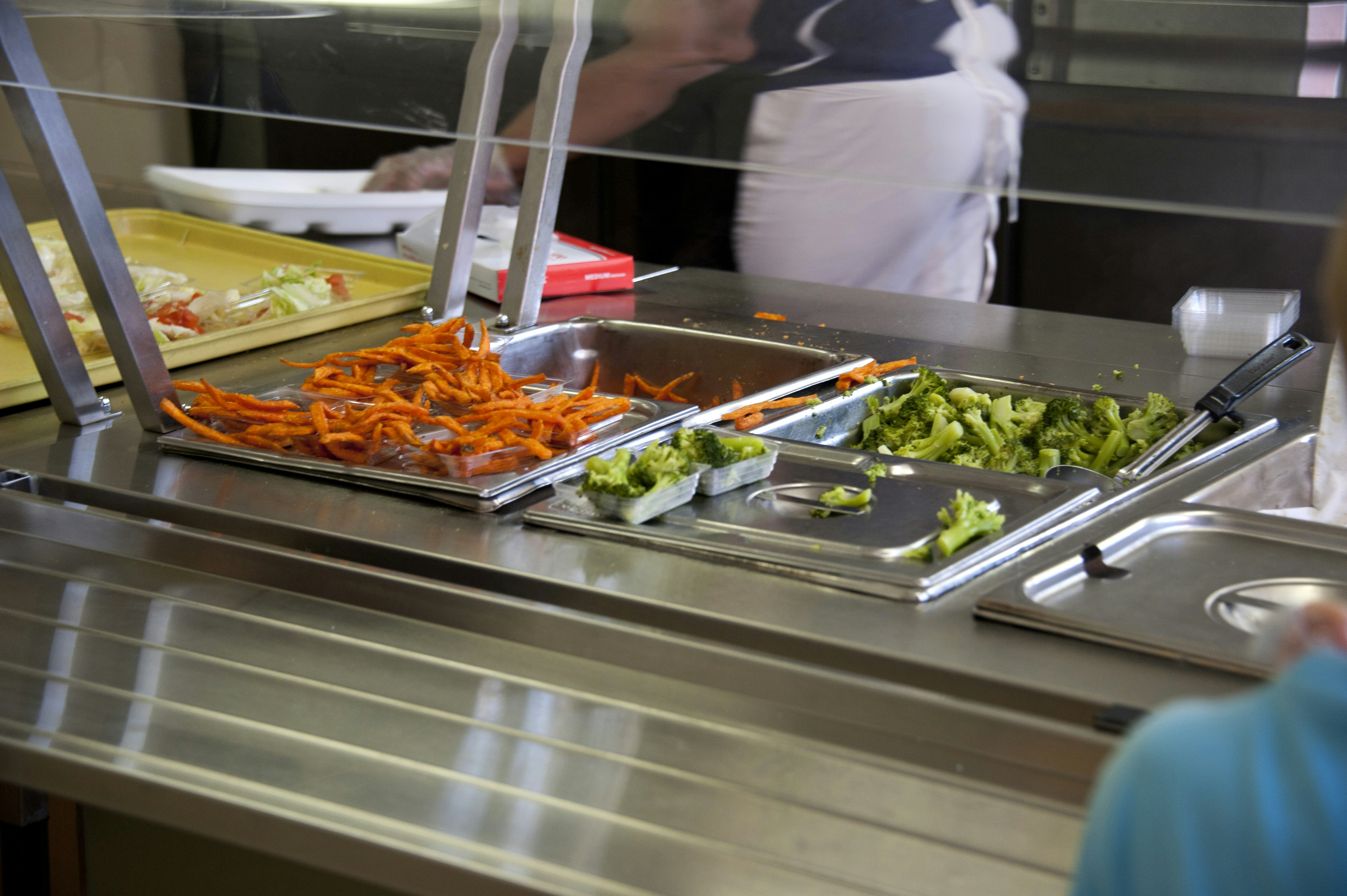 Institutional food service worker serving meals